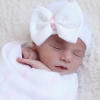 Newborn hat with white bow and pink ribbon